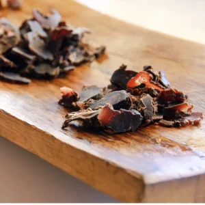 sliced biltong on a wooden serving board
