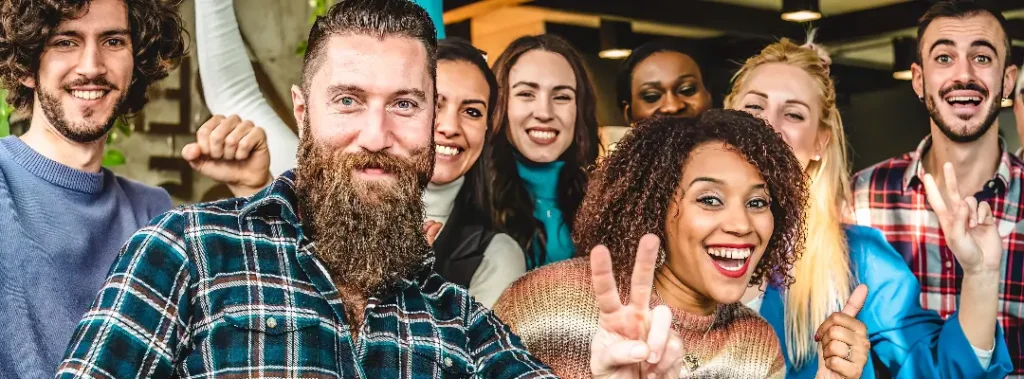 office coworkers enjoying a function together with peace signs and thumbs up.