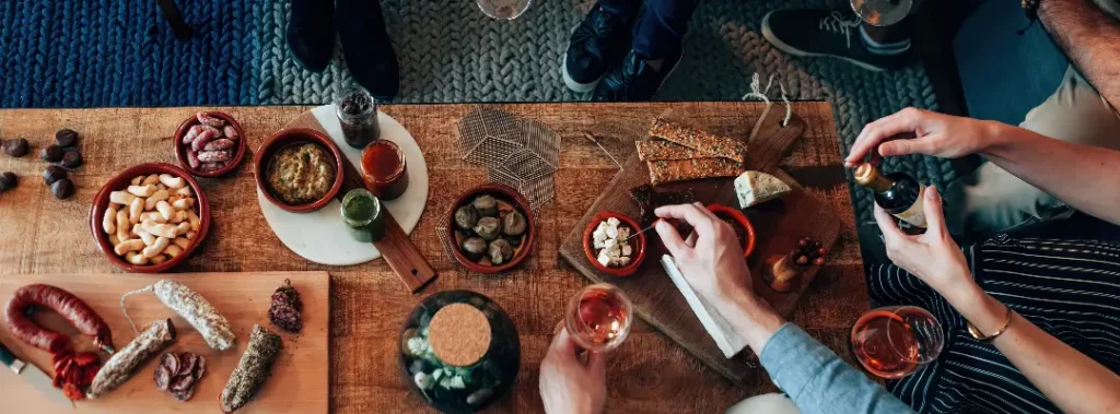 aerial view of people eating from a cheese and biltong platter