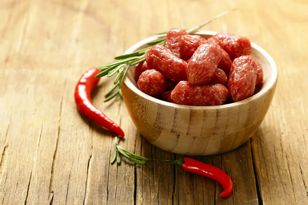 cabanossi bites in a bowl in Sandton Offices. The bowl has whole chillis around it